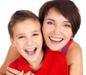 Young boy and his mother with healthy teeth